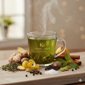 Steaming Kangra Brew Detox Tea in a clear glass cup on a wooden board. It's surrounded by ginger, cinnamon, nutmeg, cloves, black pepper, cardamom, lemon peel, tulsi, rock salt, and green tea leaves, with the gold Kangra Brew logo and soft window lighting